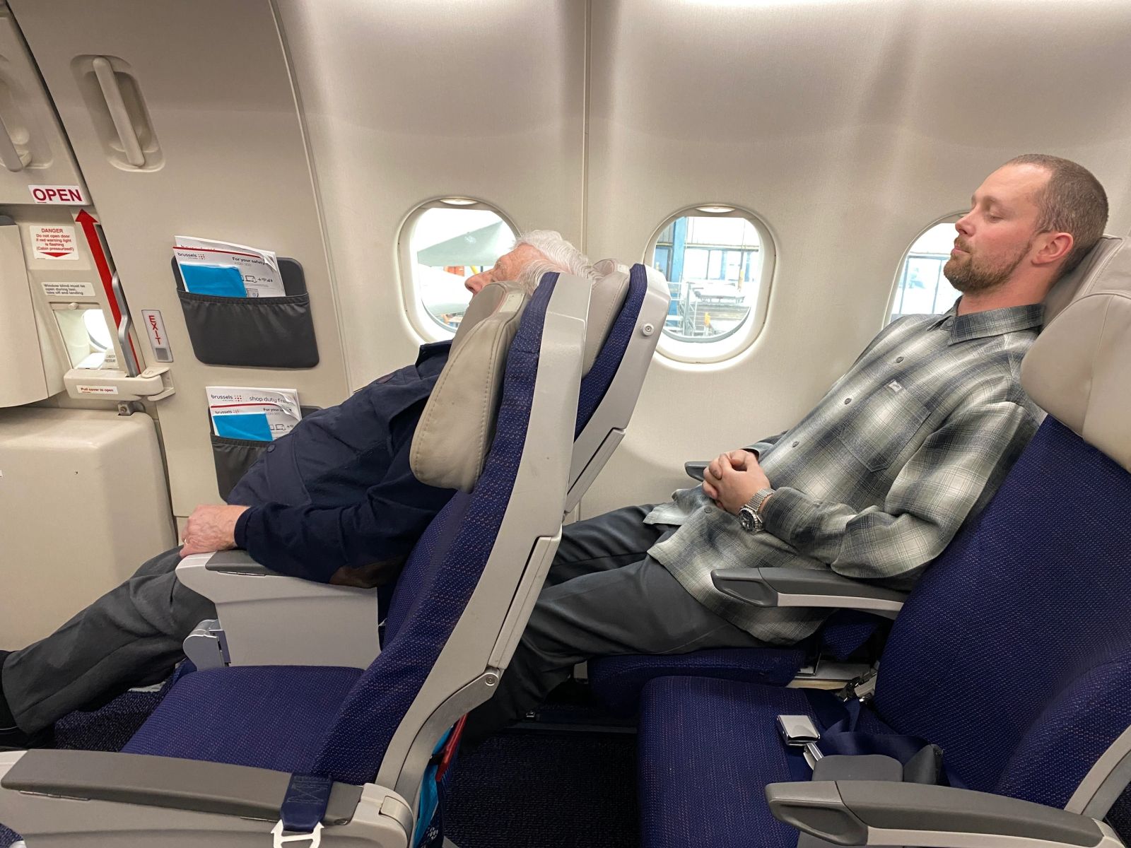 Two passengers using different LSEAT positions beside the window