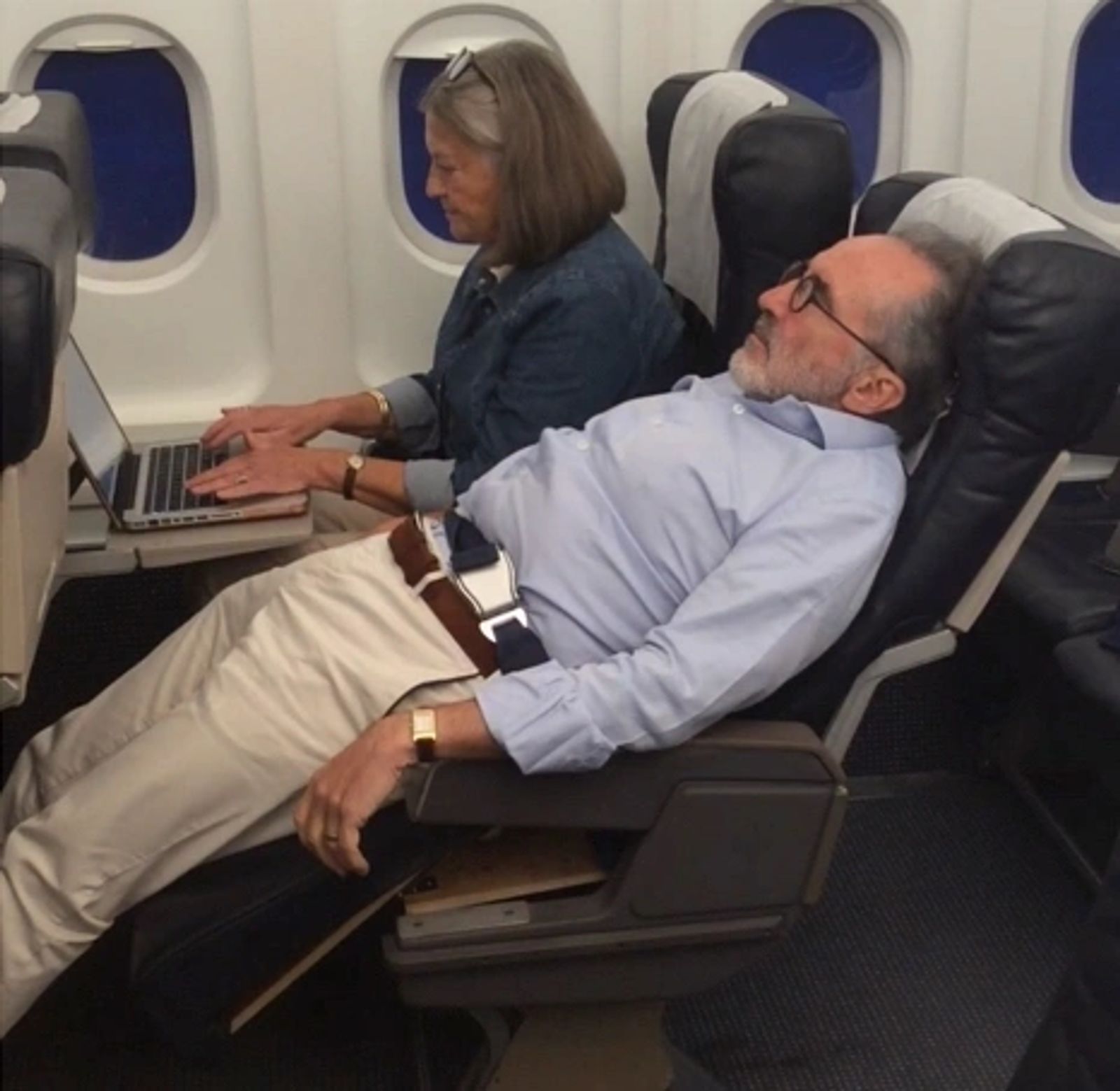Passenger reclined in an Economy seat equipped with LSEAT